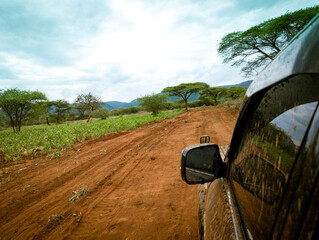 SUV Safari driving through African countryside landscape, Tanzania © Martin