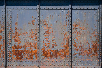 Rusty metal background - Old rundown grey and blue peeling paint reveal patterns on a rusted metal surface.