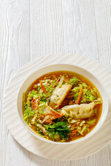 Asian Gyoza Soup in white bowl, top view
