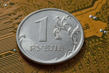 Russian 1 ruble coin. lies among the microcircuits. (a concept illustrating the pricing of electronics in Russia).