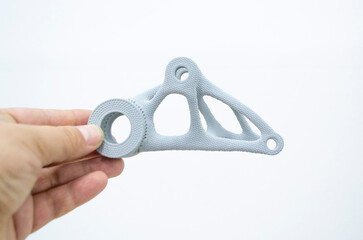 Person holding plastic model printed on powder 3d printer from biocompatible polyamide powder. Multi Jet Fusion MJF. New modern industrial 3D printing technology. Progressive additive technologies