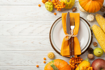 Thanksgiving day concept. Top view photo of plate knife fork napkin raw vegetables pumpkins maize...