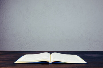 Open Bible. The book is on the table. Prayer.