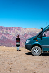 women and her campervan in Hornocal. The Serranía de Hornocal are a range of mountains located 25 kilometres (16 mi) from the city of Humahuaca in the Argentine province of Jujuy