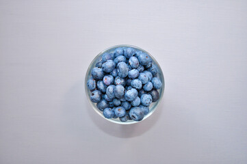 blueberry berries top view from a transparent glass isolated on a neutral background