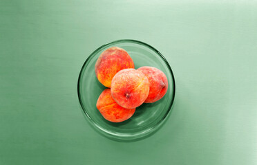 ripe peaches on a green background
