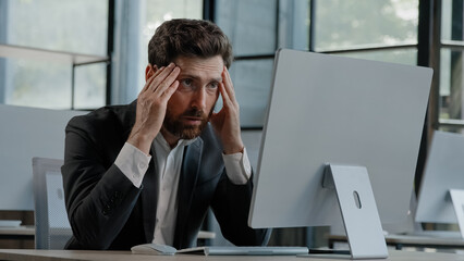Caucasian bearded 40s middle-aged businessman worker employee man typing laptop feel failure upset...