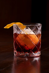 Negroni campari vermouth from the front Cocktail drink close up on wooden table portrait format