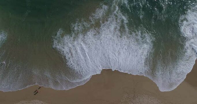 Bird's eye view of waves on a sandy beach in Acapulco, Mexico