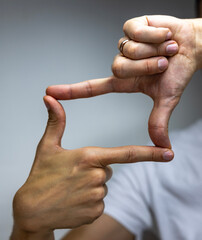 Hands showing frame. Preparing for taking pictures. 