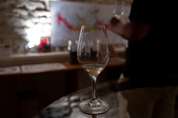 Wine tasting in underground cellars caves of French wine domain in Puligny-Motrachet village, Burgundy, France