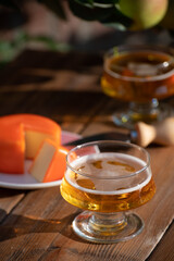 Food and drink pairing, apple cider produced on organic farm from bio apples in Normandy, France and cheddar cheese from England