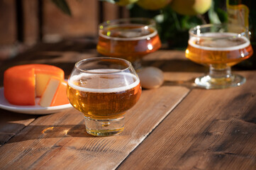 Food and drink pairing, apple cider produced on organic farm from bio apples in Normandy, France and cheddar cheese from England