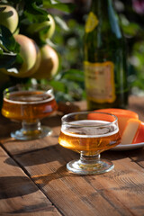 Food and drink pairing, apple cider produced on organic farm from bio apples in Normandy, France and cheddar cheese from England