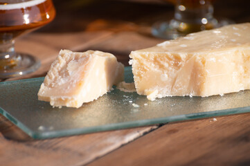 Italian cheese collection, piece of old parmigiano reggiano or parmesan cheese made from cow milk in Parma, Italy