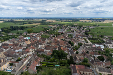 Fototapeta na wymiar Aerial view on green vineyards and Puligny-Montrachet village, production of high quality famous French white wine in Burgundy, France