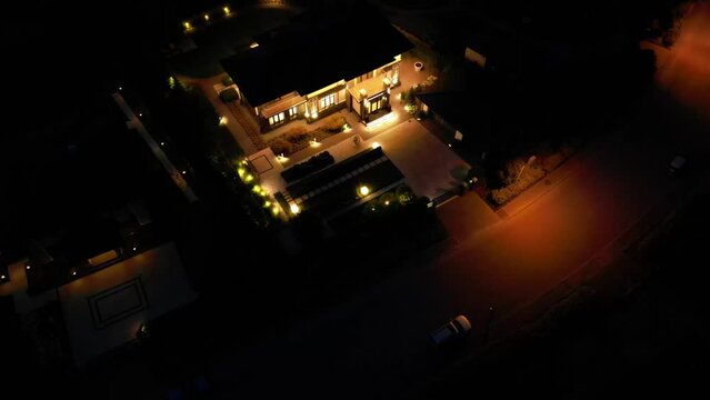 Night illumination of a country house from a drone