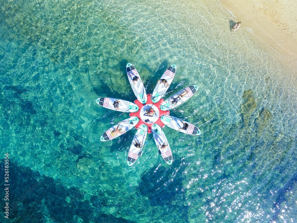 Wall mural beautiful aerial view of sup (stand up paddleboard) yoga in the mediterranean sea, croatia.