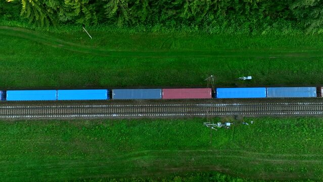 Shipping containers transportation on freight train by railway. Cargo Containers On Railroad. Intermodal Container On Train Car. Rail Freight Shipping Logistics. Multimodal Freight Transportation.