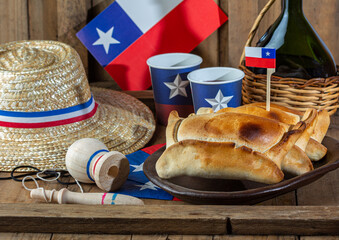 Chilean independence day concept. fiestas patrias. Tipical baked empanadas de pino, wine or chicha,...