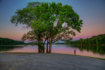 Fishing at Sunset  Crooked Creek Bay Lake Barkley Kentucky  A young fisher tries his luck in the late evening hours after sunset during the blue hour of the day.   © Larry 
