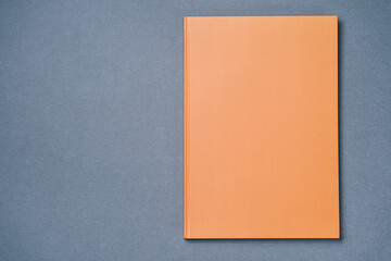 Orange Leather notebook on paper gray background, notepad mock up, top view shot