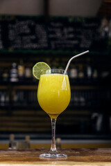 Orange juice served in a glass and decorated with a slice of lemon in a restaurant.