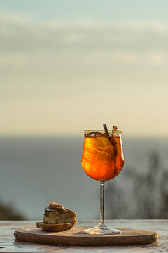 Orange cocktail served with a tapa by the pool. Summer vibes. Fresh, natural. Elegant