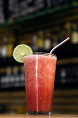 Strawberry shake served in a glass with a glazed rim at a restaurant bar