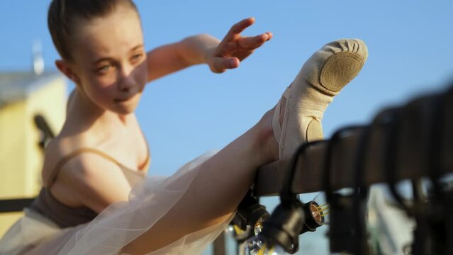 close-up young ballerina dancing and warming up
