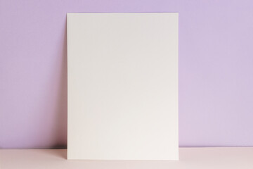 Blank card or poster mock-up over pastel purple wall