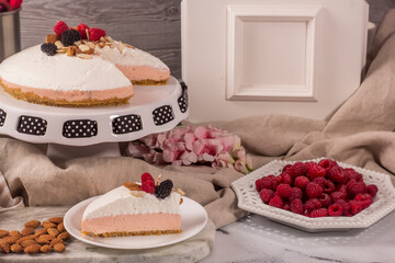 Blackberry pie decorated with almonds and red berries