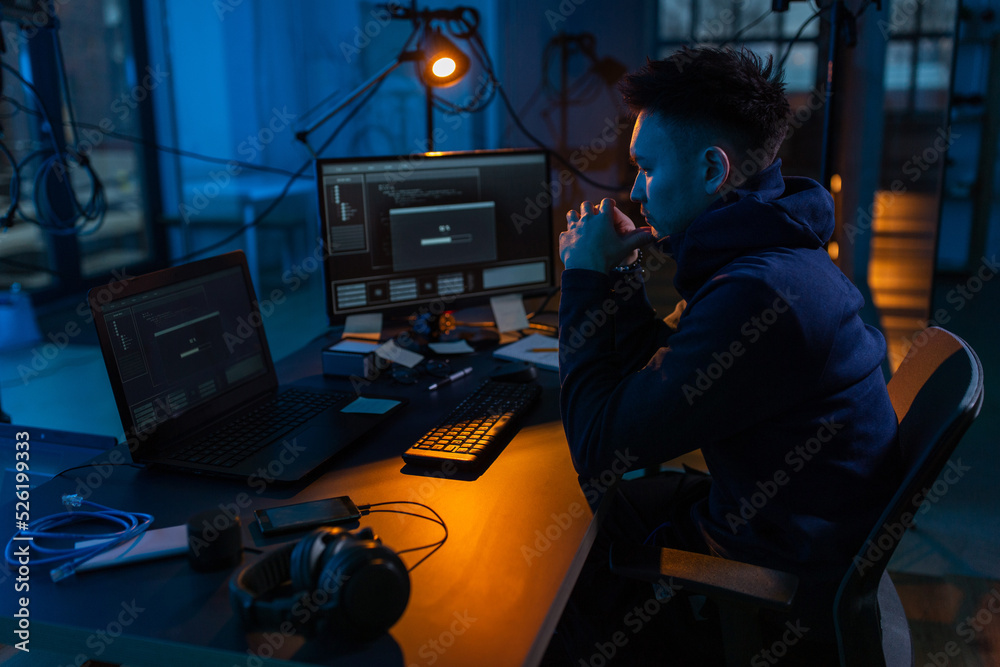 Poster cybercrime, hacking and technology concept - male hacker in dark room using computer virus program f