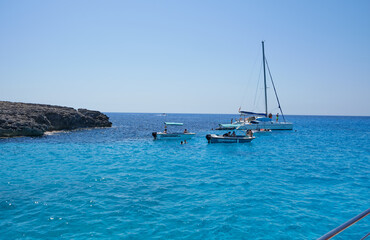 Obraz premium Menorca, Spain: Beautiful bay with sailing boat catamaran
