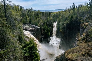 Fototapeta na wymiar Aguasabon Falls and Gorge in Terrace Bay, Ontario, Canada along Lake Superior. Beautiful ferocity in the spring. Waterfall cascades into the Aguasabon Gorge in Canadian wilderness. 