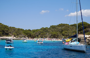 Fototapeta na wymiar Menorca, Spain: Beautiful bay with sailing boat catamaran