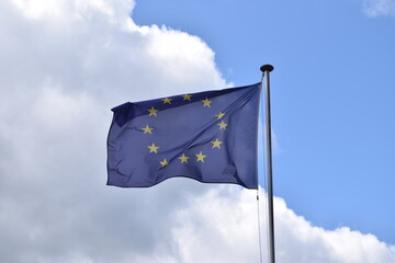 European Union flag on a cloudy day. EU banner in the wind