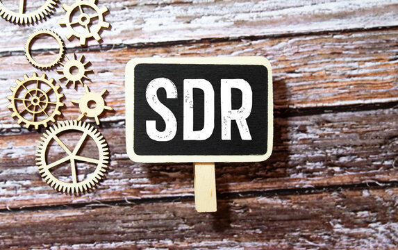 SDR Special Drawing Rights Is The Acronym Behind Torn Office Paper With Numbers.