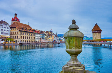 The stone urn on the embankment of Reuss river and view on Altstadt district of Lucerne city,...