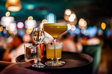 alcohol cocktail set on a waiter tray in bar