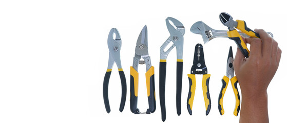 hand holding pliers and different types of black yellow hand tools isolated white background