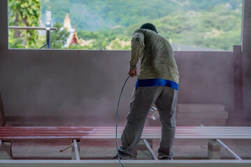 Professional painters are painting the interior of the house.