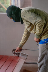 Professional painters are painting the interior of the house.