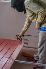 Professional painters are painting the interior of the house.