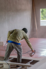 Professional painters are painting the interior of the house.
