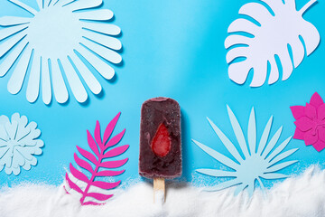mulberry and blue berry flavor popsicle with leaves and white sands