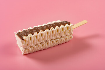 angle view vanilla and chocolate flavor popsicle on a pink background