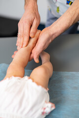 Feet massage making for child. Tiny baby leg massaging.