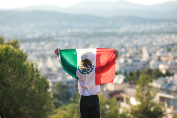 People holding flag of Mexico. 