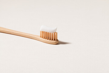 close up of bamboo toothbrush with toothpaste.